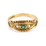 A 9ct gold dress ring, the marquise shaped top set with emerald and seed pearls, with heart ringed s
