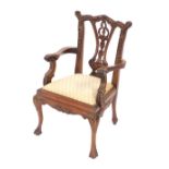 A mahogany child's chair, in the Chippendale style with cream drop-in seat, 52cm high, 33cm wide. Th