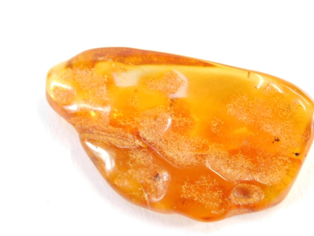 A piece of natural amber, with various growth specks and rubbed detailing, 5cm wide, 12.4g all in. - Image 3 of 3