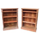 A pair of Victorian mahogany open bookcases, each with three pine shelves, flanked by turned demi pi