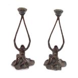 A pair of Art Nouveau style bronzed spelter frog candlesticks, each depicting frog holding candle st