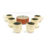 A Denby green glazed set of six cups and saucers, each on a cream coloured ground with green interio