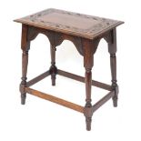 An early 20thC carved oak side table, the rectangular top of star and sun detailing, on a rectangula