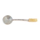 A white metal Mexican spoon, with hammered Aztec detailing on a carved soapstone handle, stamped ALP