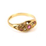 A 9ct gold gypsy ring, with five stone set band, with three garnets and two tiny diamonds, with scro