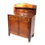 A late Regency mahogany chiffonier, the pendimented back with a single shelf raised on turned column