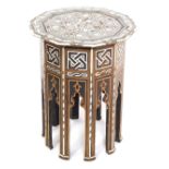 An early 20thC Damascus type mother of pearl inlaid table, the top raised on panelled sides, with mi