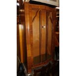 An Art Deco style walnut bow front china cabinet.