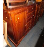 A Ducal pine sideboard, with six drawers flanked by cupboards.