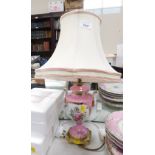 A continental porcelain table lamp, with white painted finish and flowers, with brass base and shade