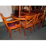 A yew wood extending dining table and 6 chairs, including two carvers. The upholstery in this lot d