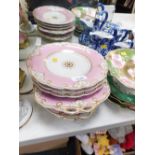 A group of 19thC porcelain plates, each on a pink ground with gilt border, comprising three dinner p