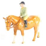 A Beswick figure boy on pony, printed marks beneath, 15cm high.