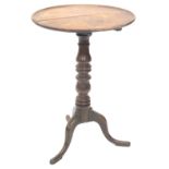 A 19thC oak tilt top table, the circular dish top on a turned column and tripod base, the top 50cm d