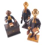 Three Italian Romer carved wooden figures, of a judge and two barristers, holding cases, 24cm high.