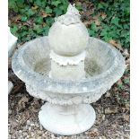A composition stone fountain, of urn form decorated with fruit, leaves, etc., with central finial, 6