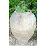 A stoneware bullet shaped olive jar, 90cm high.