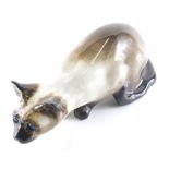 A 20thC Winstanley figure of a crouching cat, signed beneath, 13cm high.