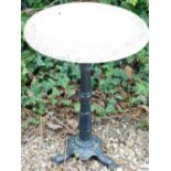 A cast iron garden table with circular white marble top, 49cm diameter.