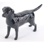 A Beswick pottery black Labrador, standing, printed marks beneath, 15cm high.