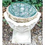 A composite stone garden urn, 38cm high, and various hanging baskets.
