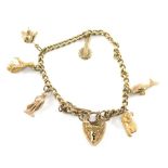 A 9ct gold and other charm bracelet, with heart shaped clasp to include a number of charms to includ