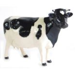 A Beswick Friesian cow, Claybury Leegwater, printed marks beneath, 12cm high.