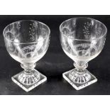 A pair of late 18thC/early 19thC Masonic glass rummers, each engraved with symbols and panels, on a