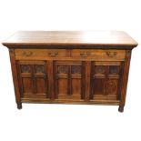A late 19thC Arts and Crafts oak sideboard, the rectangular top with a moulded edge above two frieze