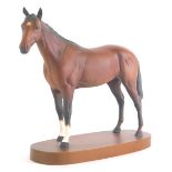 A Beswick horse, in brown on wooden plinth base, printed marks beneath, 22cm high.