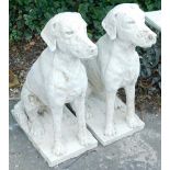 A pair of composition models of seated hounds, each on a rectangular base, 77cm high.