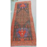 A ground and heavy pile Persian Navahan village carpet, with a design of a pole medallion, geometric