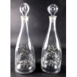 A pair of early 19thC Masonic glass decanters, etched with emblems and fern leaves, with bullseye st