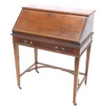 An Edwardian mahogany and satinwood cross banded bureau, the fall enclosing a fitted interior above