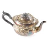 An early 20thC silver teapot, repousse decorated with scrolls, with an ebonised thumb mould handle a