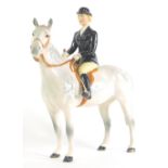 A Beswick black jacketed huntswoman, printed marks beneath, 23cm high.