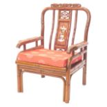 A Chinese hardwood open armchair, the back inlaid in mother of pearl with flowers, etc., carved with