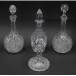 A pair of cut glass bottle shaped decanters and associated stoppers, and two other further cut glass