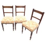 A set of three late 19thC walnut side chairs, each with a padded seat on turned legs.