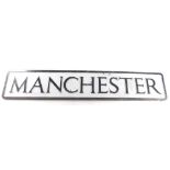 A 20thC metal city sign Manchester, in black and white, 100cm wide.