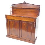A Victorian figured mahogany chiffonier, the raised back with arched top carved with leaves, above a