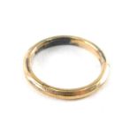 A wedding band, of plain design, yellow and white metal stamped 9ct gold on silver, ring size K, 2.2