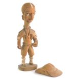 Tribal art. A figure of a British soldier with moustache, wearing uniform, hat, etc., 22cm high.