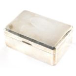 A George VI silver cigarette box, with engine turned canted top, thumb mould handle and cedar lined