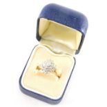 An 18ct gold and diamond ladies floral cluster ring, set with twenty one diamonds, size M.