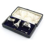 A George V silver condiment set, comprising pepper pot of baluster form, 9cm high, open salt and mus