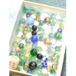 A modern book box, containing a quantity of marbles.