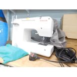 A Singer electric sewing machine with pedal, etc., model number 1409.