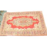 A Persian rug, the outer field with a floral geometric pattern, the inner section with elongated flo