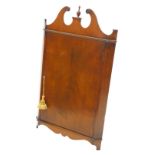 A figured mahogany corner cabinet, in George III style with a shaped swan neck pediment, flanking a